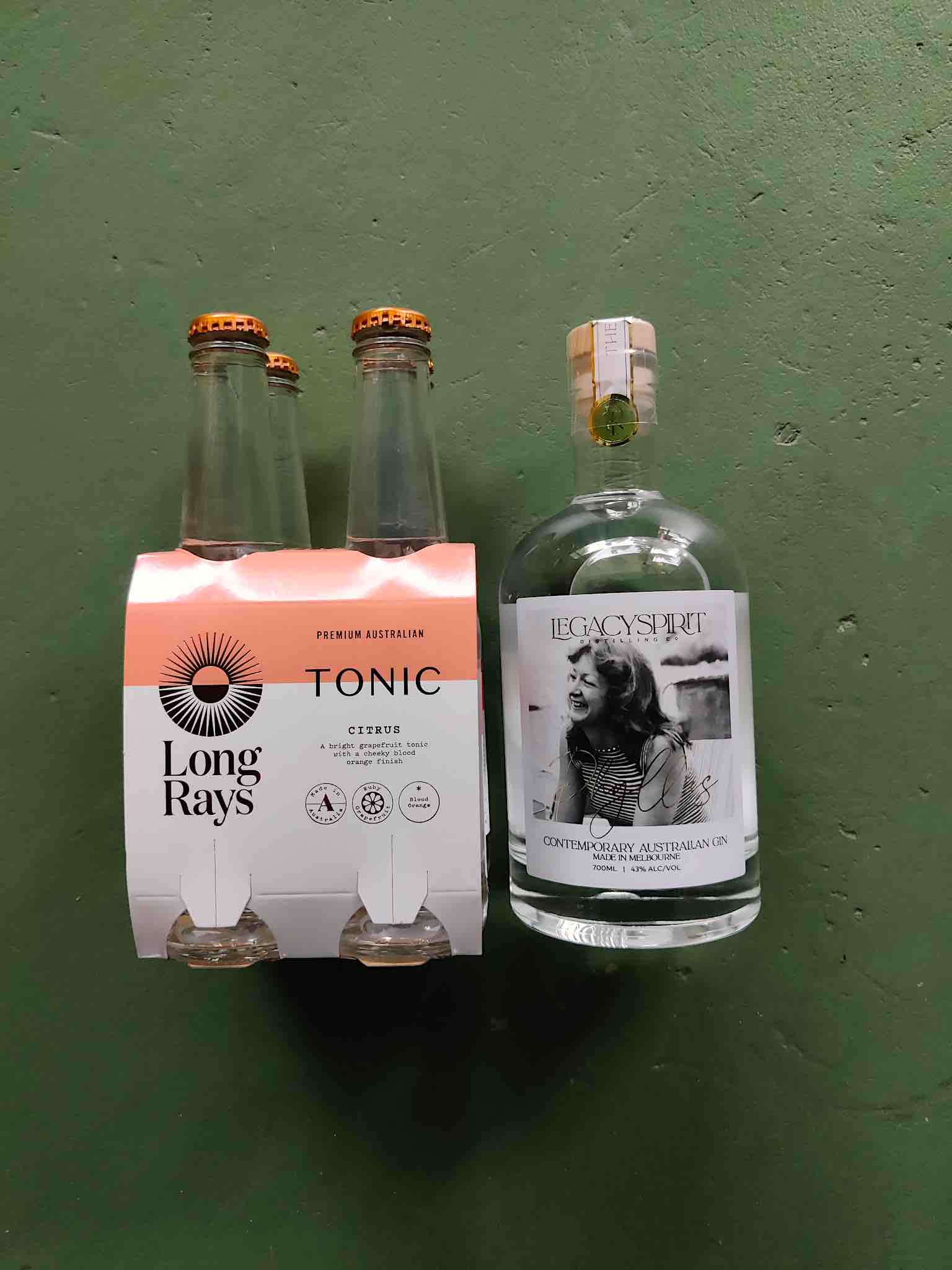 A bottle of Legacy Spirit Phyllis Gin with a 4 pack of Long Rays Citrus Tonic.